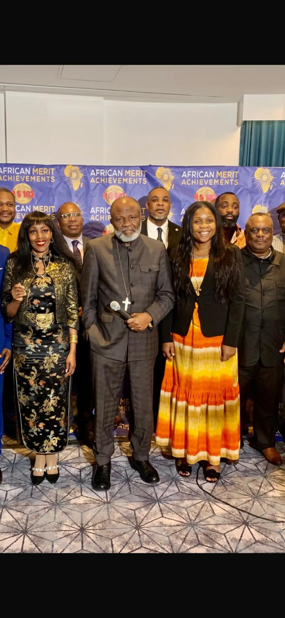 Guests posing in front of the African Merit Achievements banner at Forum London 2023