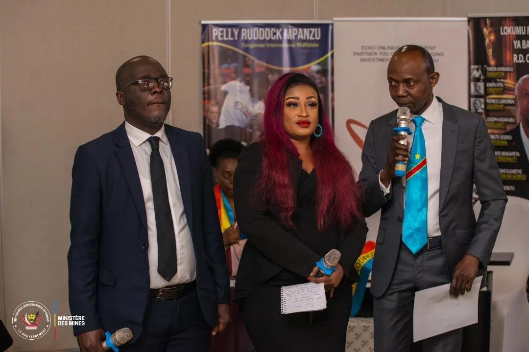 Two men and a woman holding microphones during a forum session